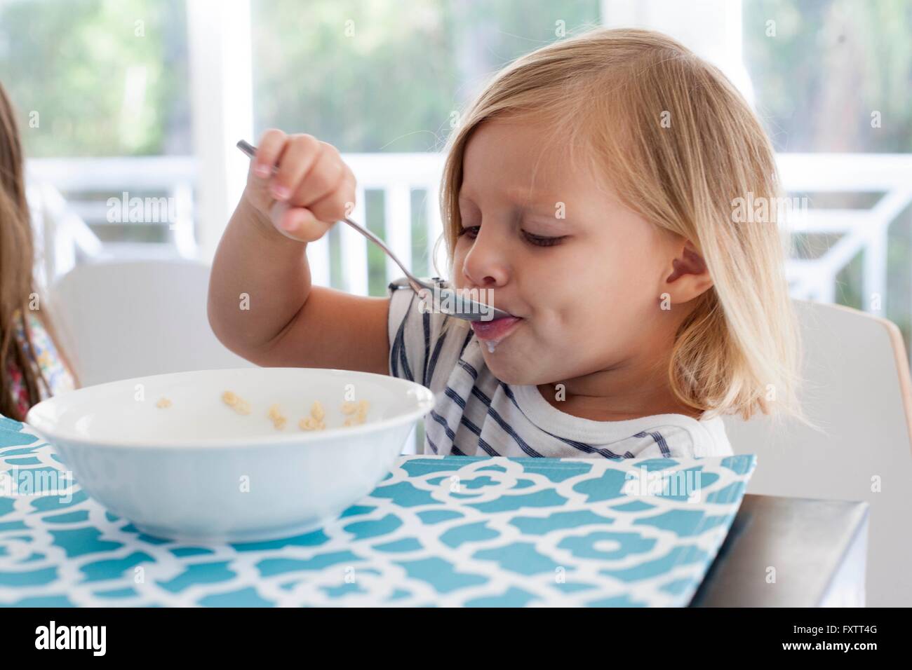 Girl eating breakfast hi-res stock photography and images - Alamy