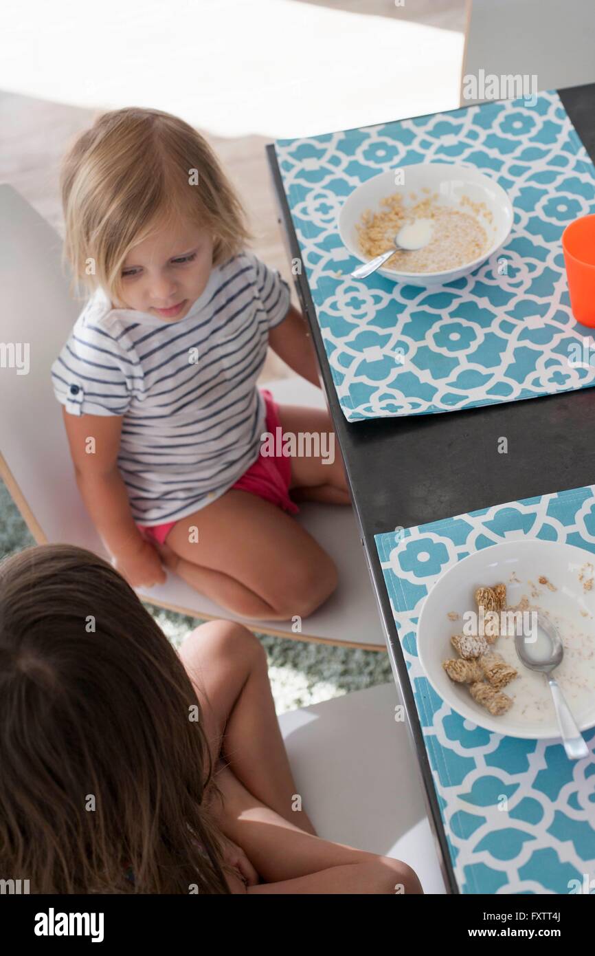 High angle view of sisters at dining table eating breakfast Stock Photo ...