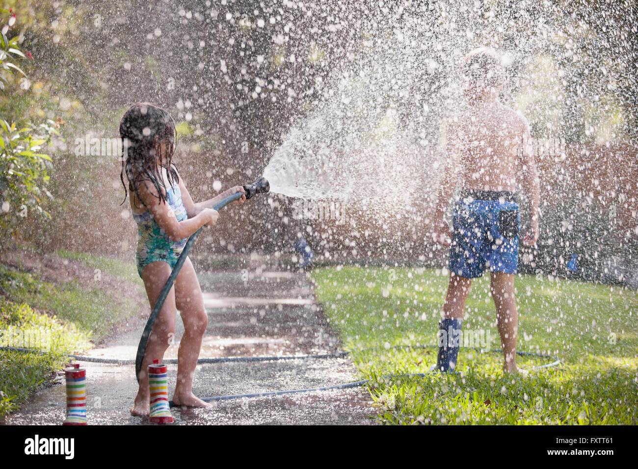 Children playing with water hose on sidewalk Stock Photo 102578729 Alamy