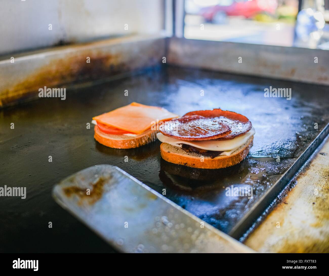 Pork roll sandwich cooking on catering van griddle Stock Photo