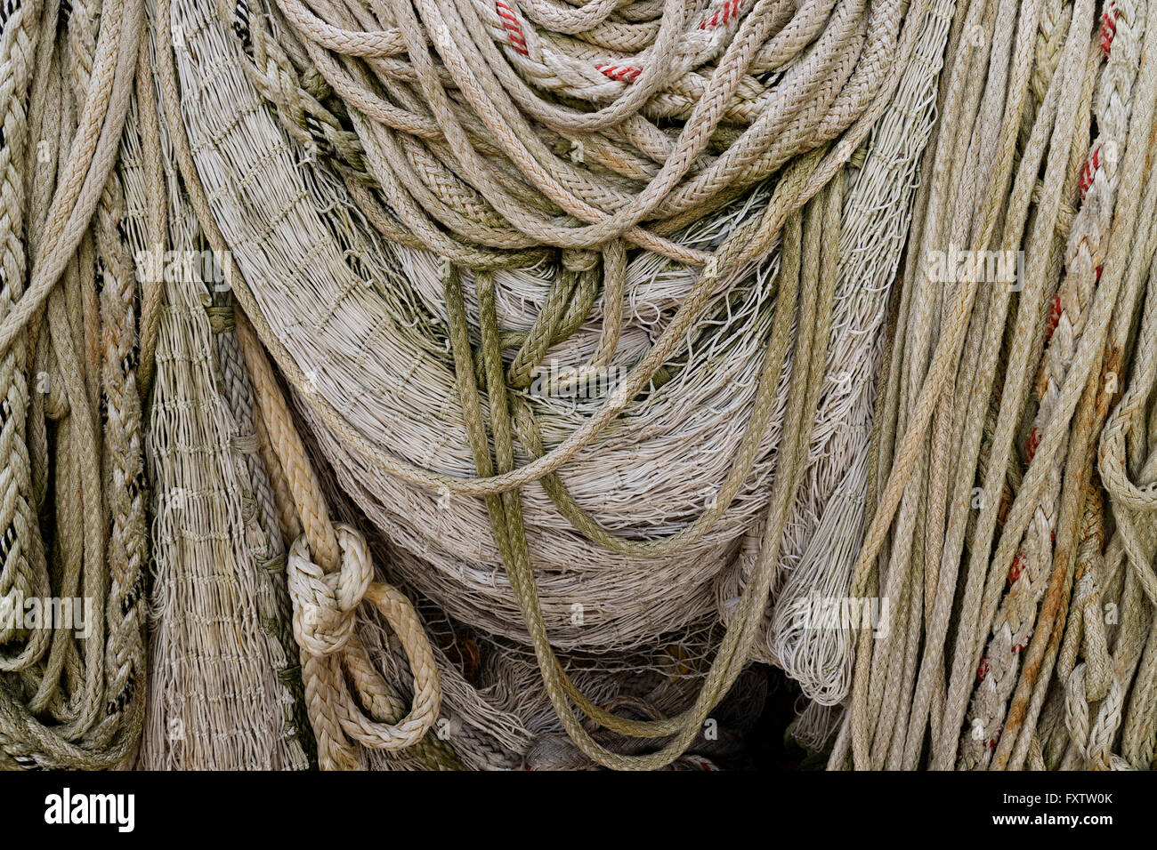 Pile of ropes and fishing nets hanging to dry Stock Photo