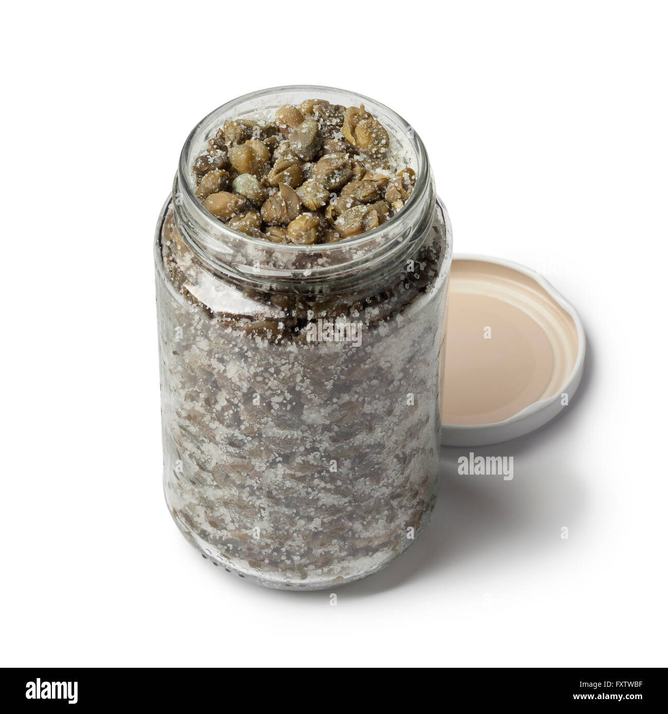 Salted capers in a glass jar on white background Stock Photo
