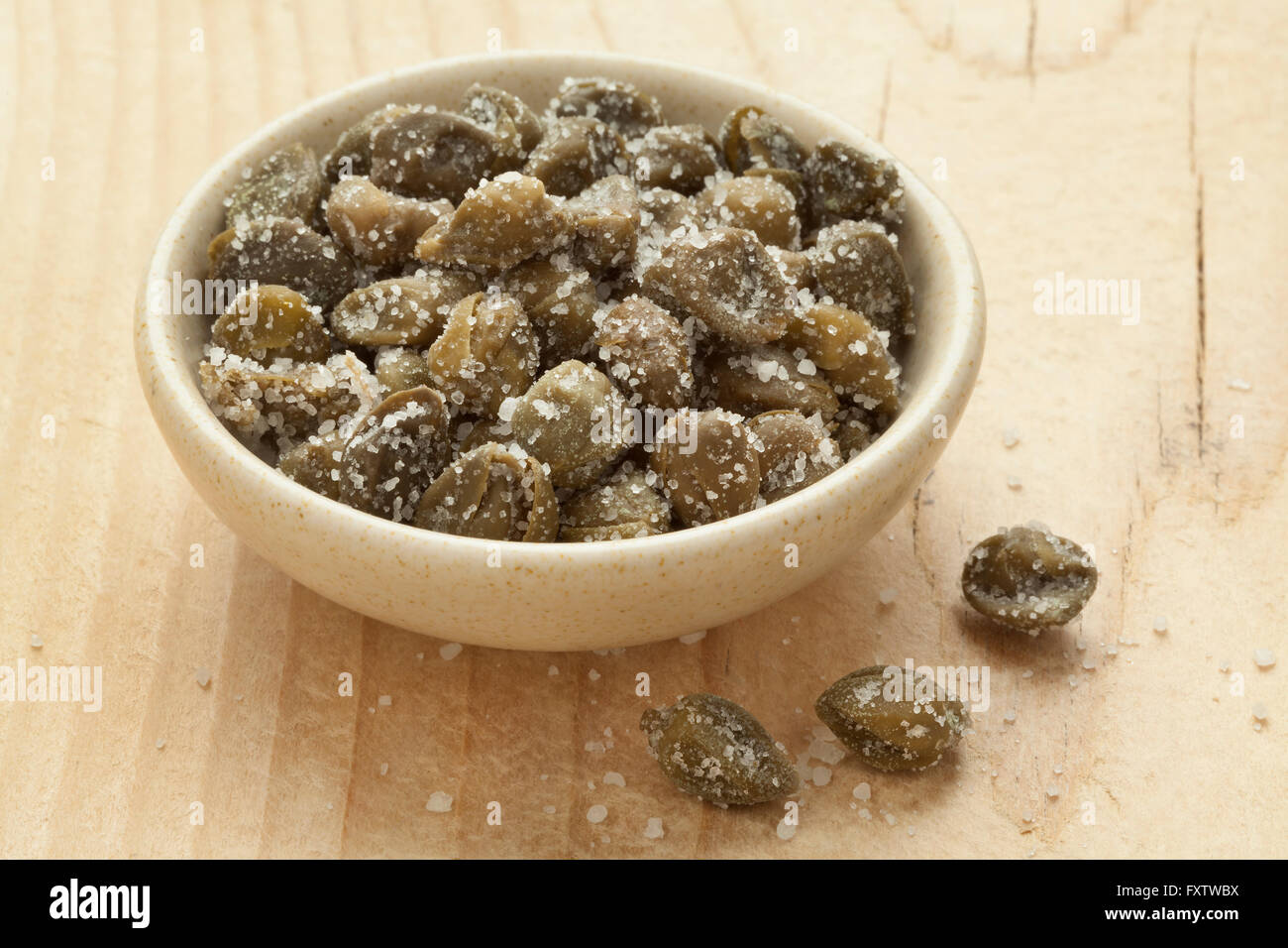 Salted capers in a bowl Stock Photo Alamy