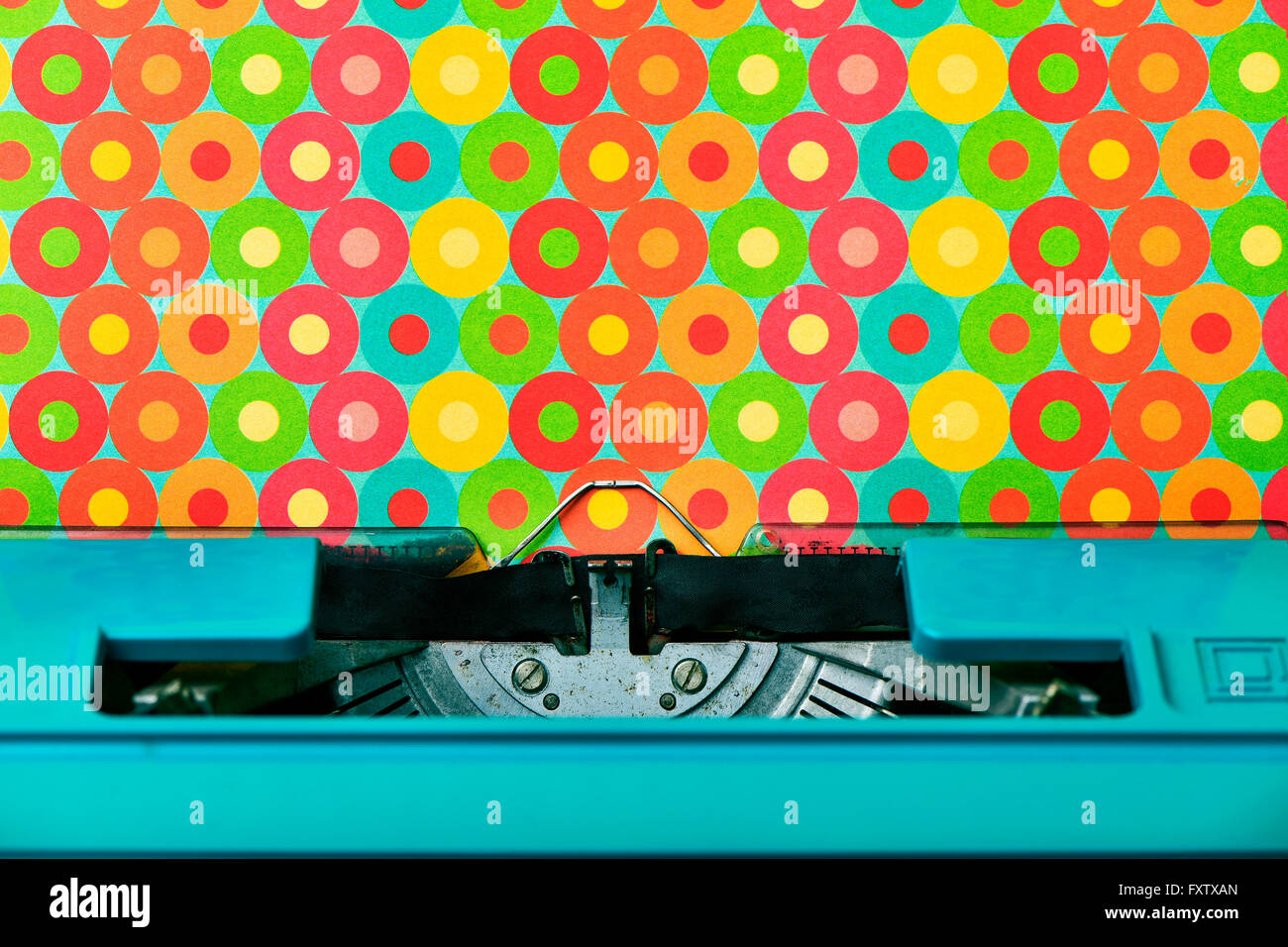 closeup of a colorful patterned paper in an old blue typewriter Stock Photo