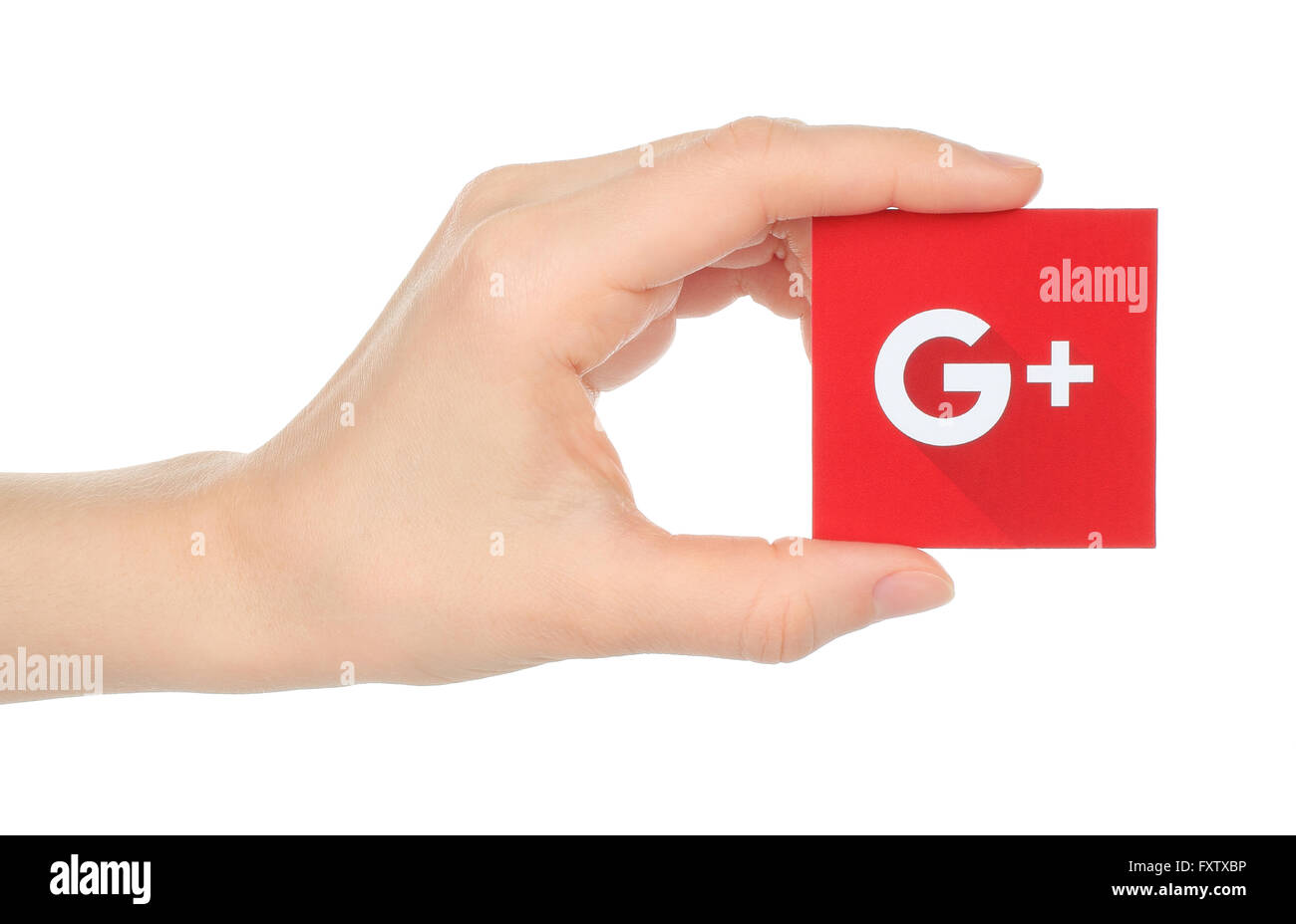 Kiev, Ukraine - January 15, 2016:Hand holds new Google plus logotype printed on paper and cut, on white background.Google is USA Stock Photo