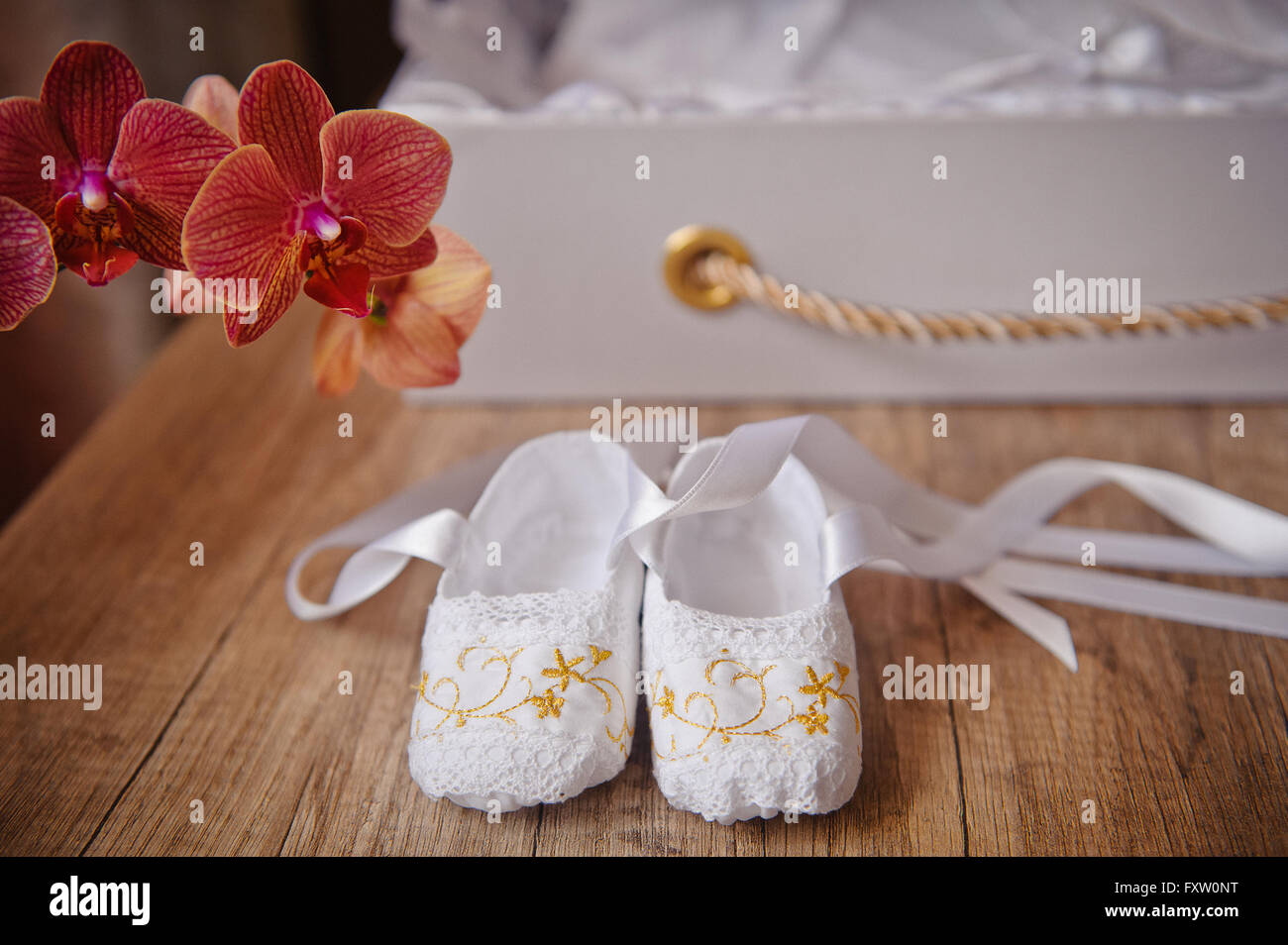 pair of Childrens ballet shoes worn and flowers Stock Photo
