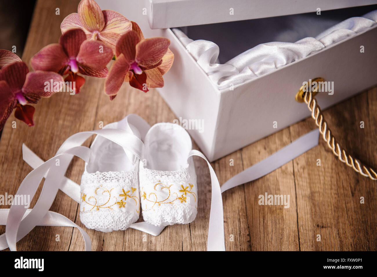 pair of Childrens ballet shoes worn and flowers Stock Photo