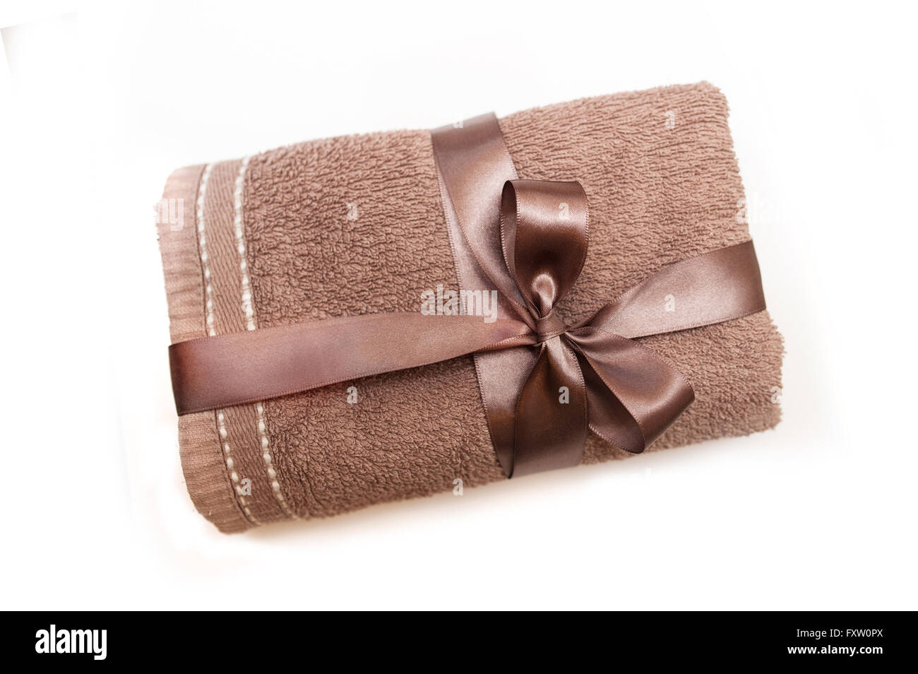 brown towel tied with a ribbon and bow Stock Photo