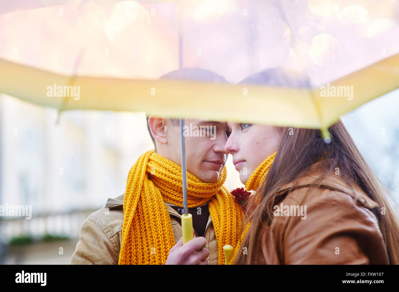 Beautiful young loving couple under an umbrella in the rain Stock Photo ...