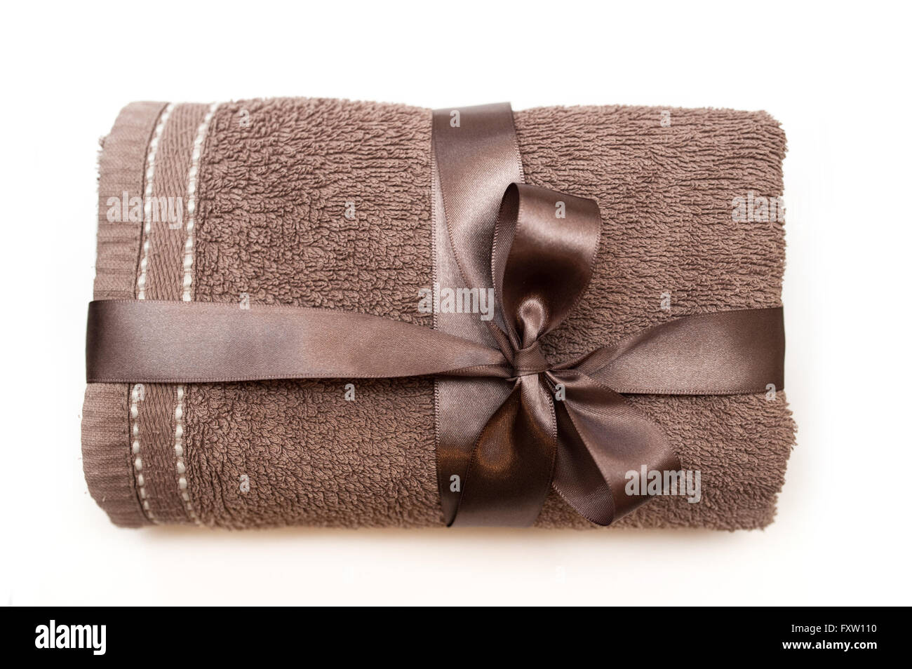 brown towel tied with a ribbon and bow Stock Photo