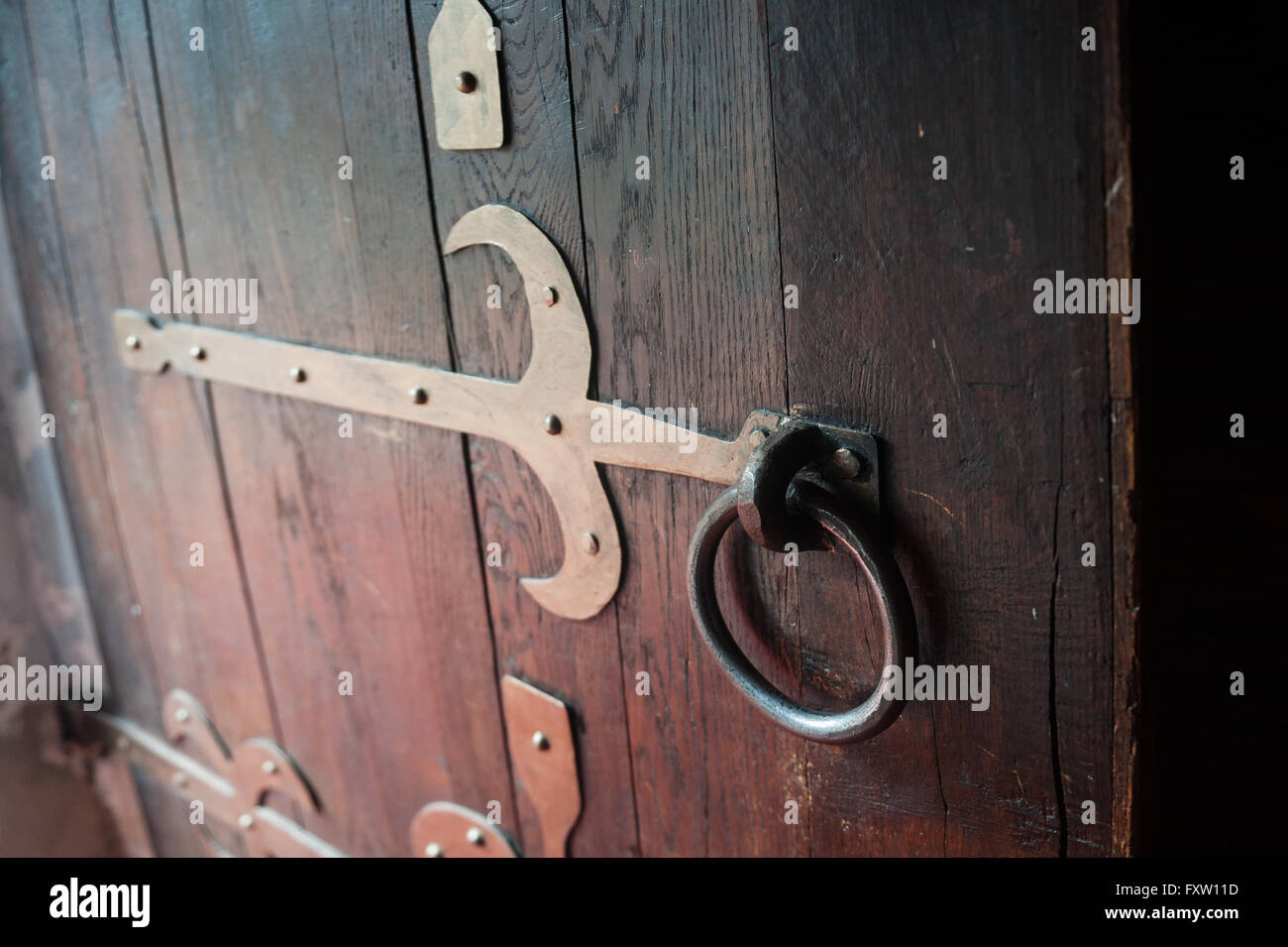 close up old wooden door with metal loops Stock Photo