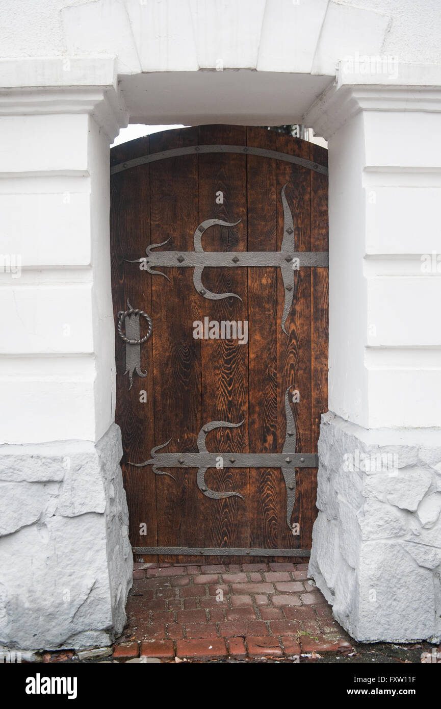 close up old wooden door with metal loops Stock Photo