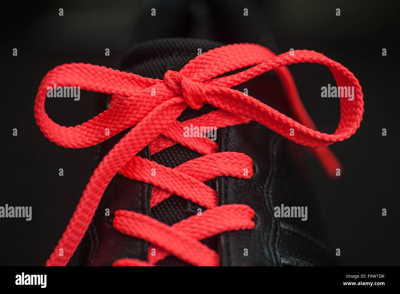 pink laces on black shoes Stock Photo - Alamy
