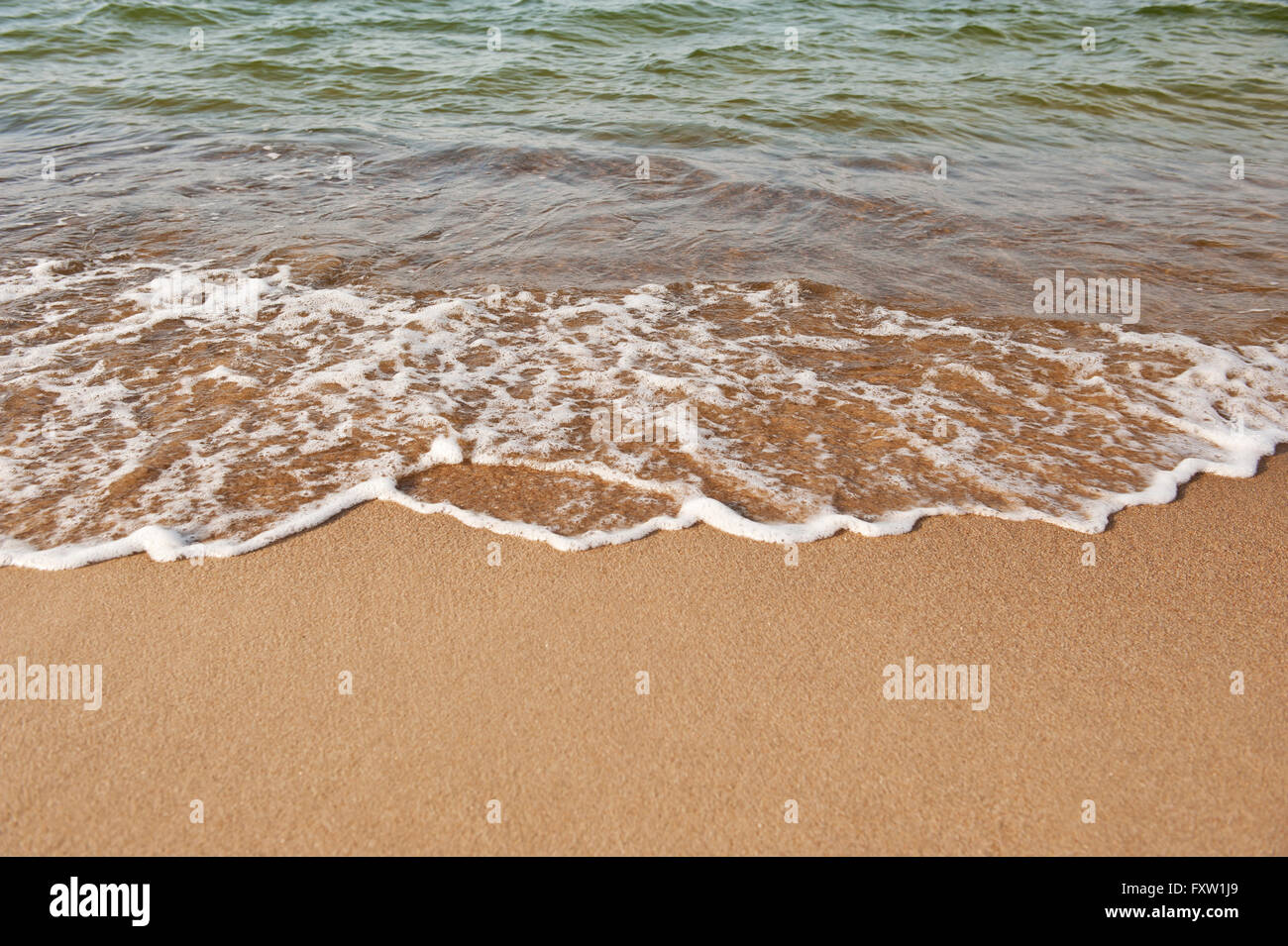 Sea shore edge and sand closeup at the Wladyslawowo beach, Poland, Europe. Calm water and peaceful nature detail abstracts Stock Photo