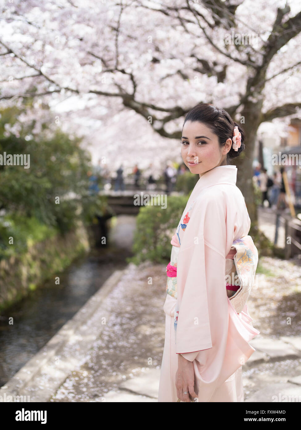 Japanese woman in kimono at The Philosopher's Walk near Ginkaku-ji Temple, Kyoto, Japan during cherry blossom Stock Photo