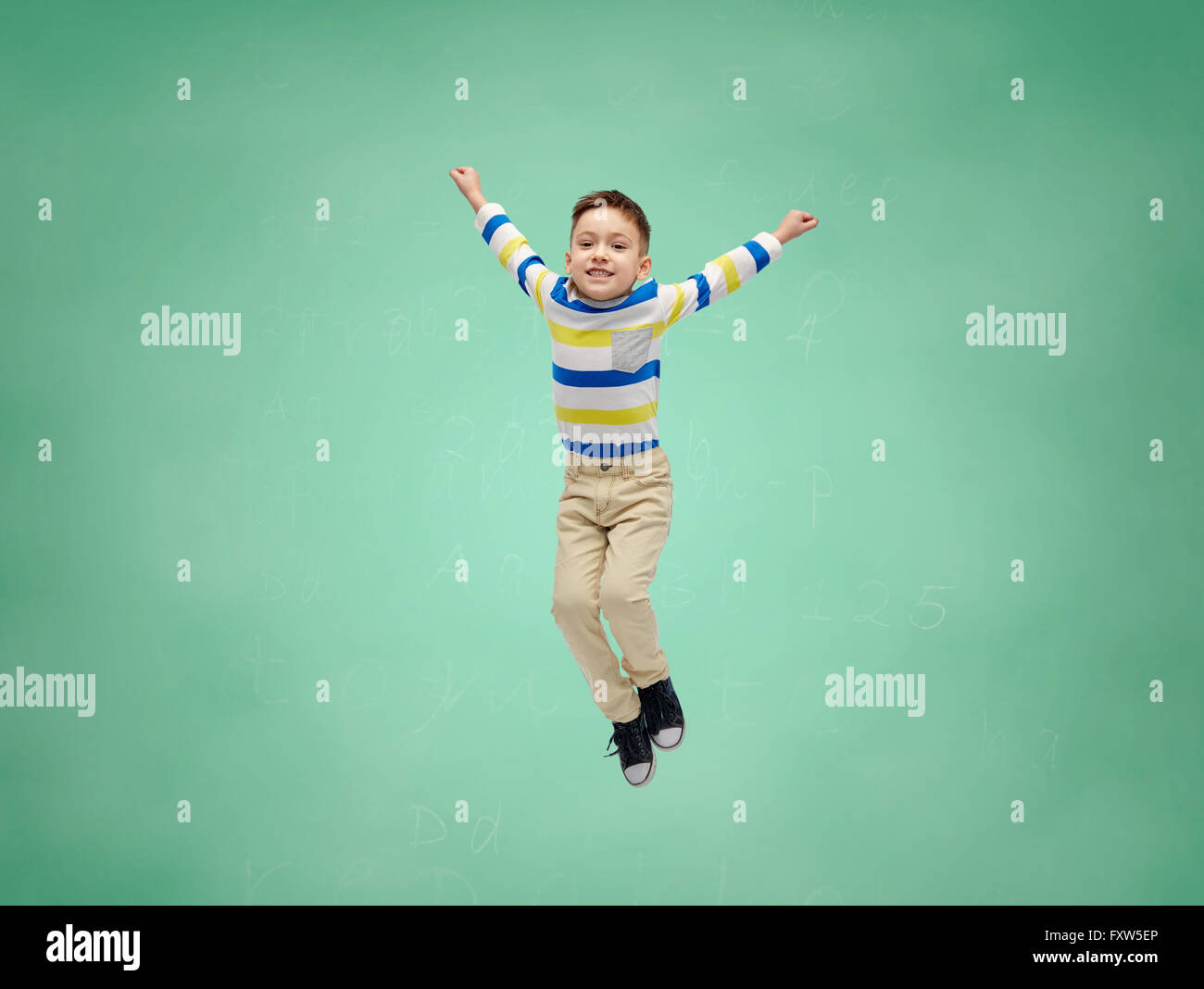 happy little boy jumping in air over school board Stock Photo - Alamy