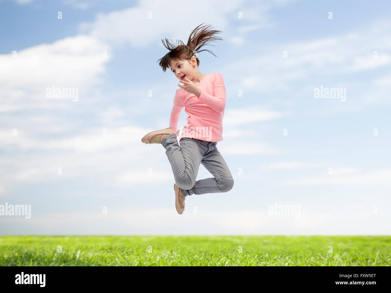 happy little girl jumping in air Stock Photo - Alamy