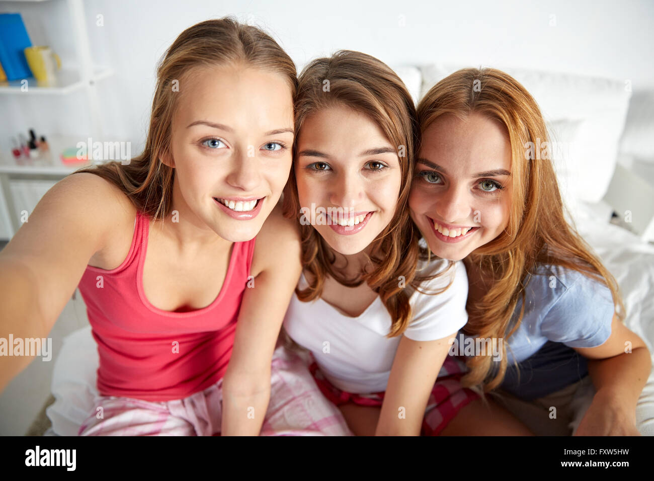 Happy Friends Or Teen Girls Taking Selfie At Home Stock