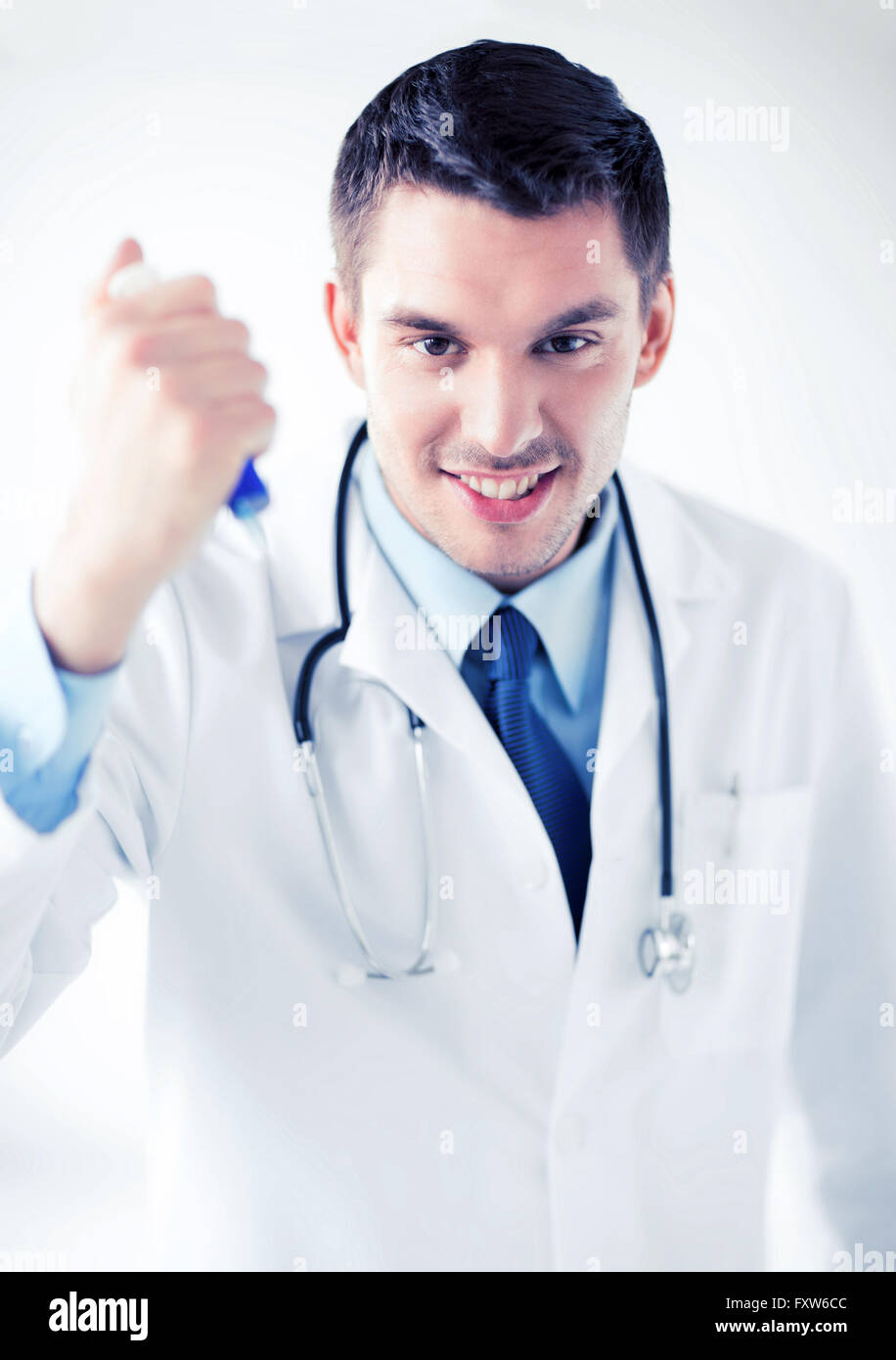 evil doctor holding syringe with injection Stock Photo