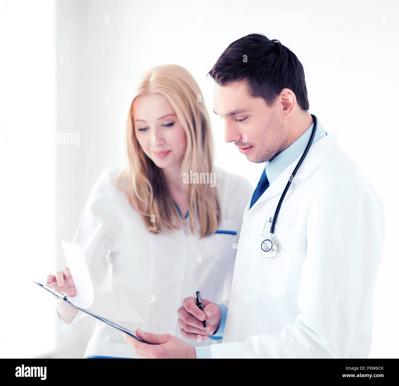 two doctors writing prescription Stock Photo Alamy