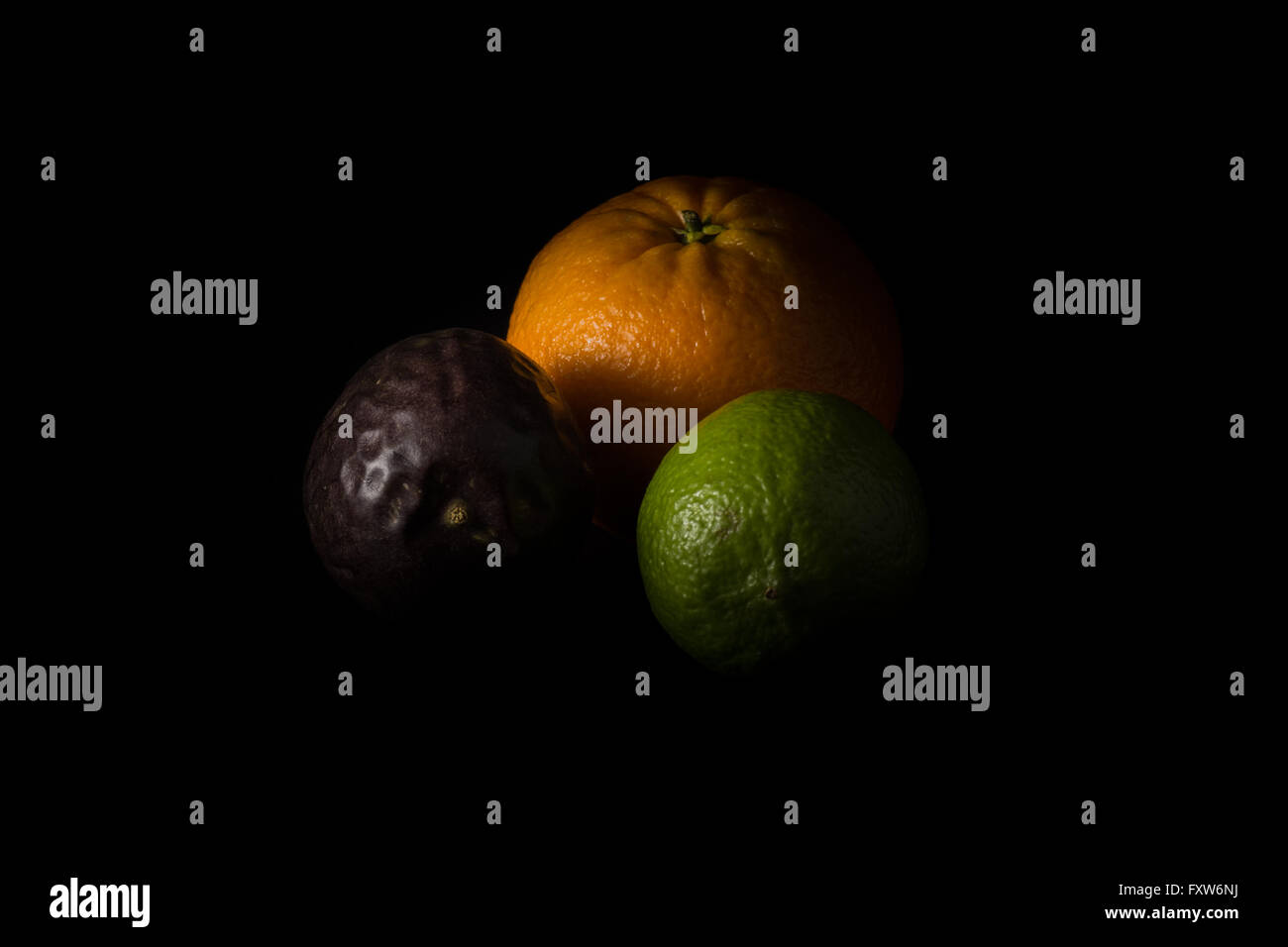 Orange, passion fruit and lime low key image Stock Photo