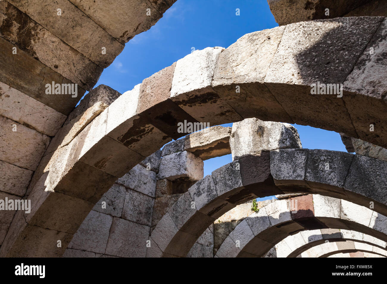 Ruined stone corridor with arches. Ruins of Ancient city Smyrna. Izmir ...