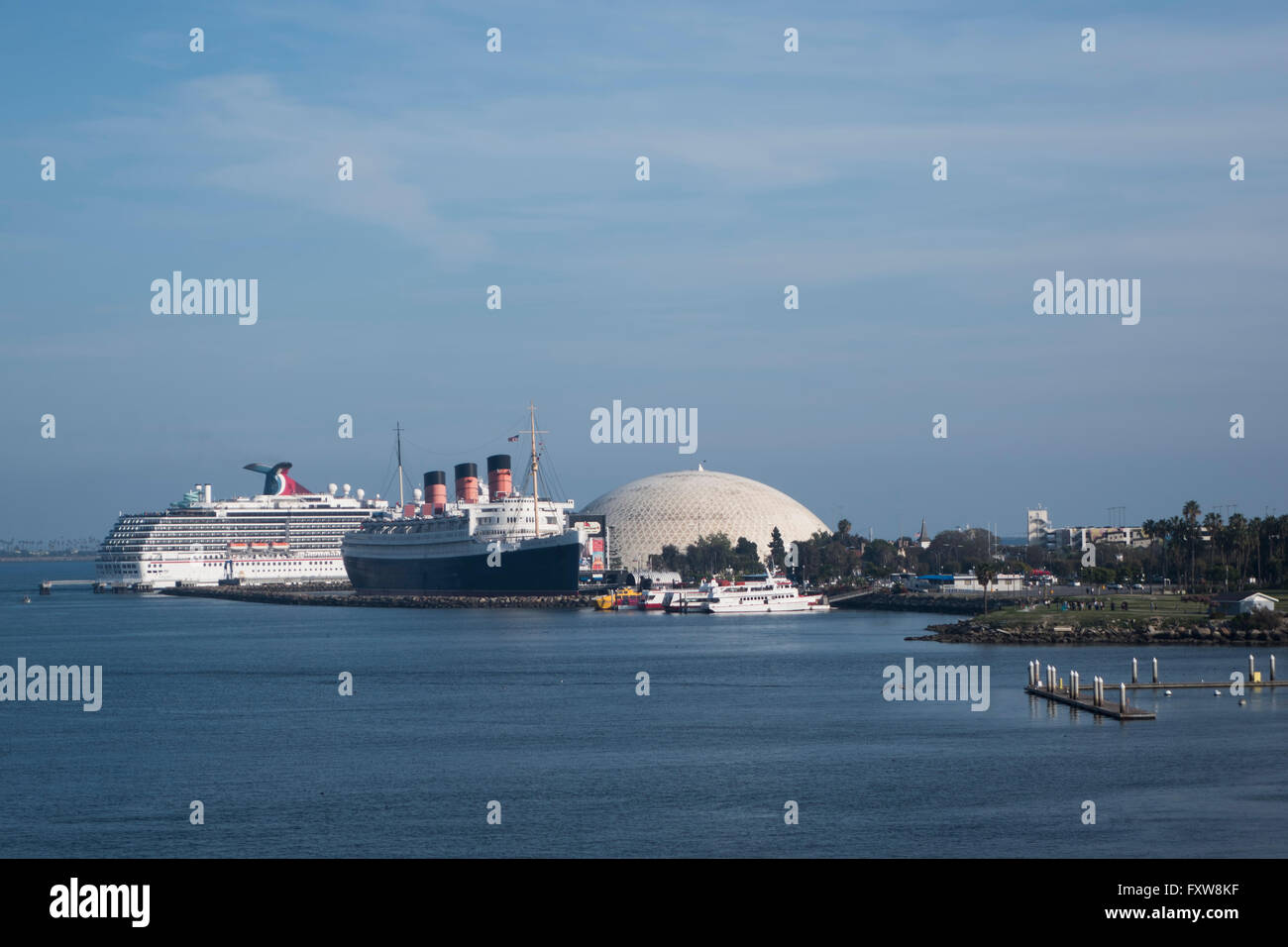 The Queen Mary berthed at Longbeach California with carnival cruiseliner in the background Stock Photo