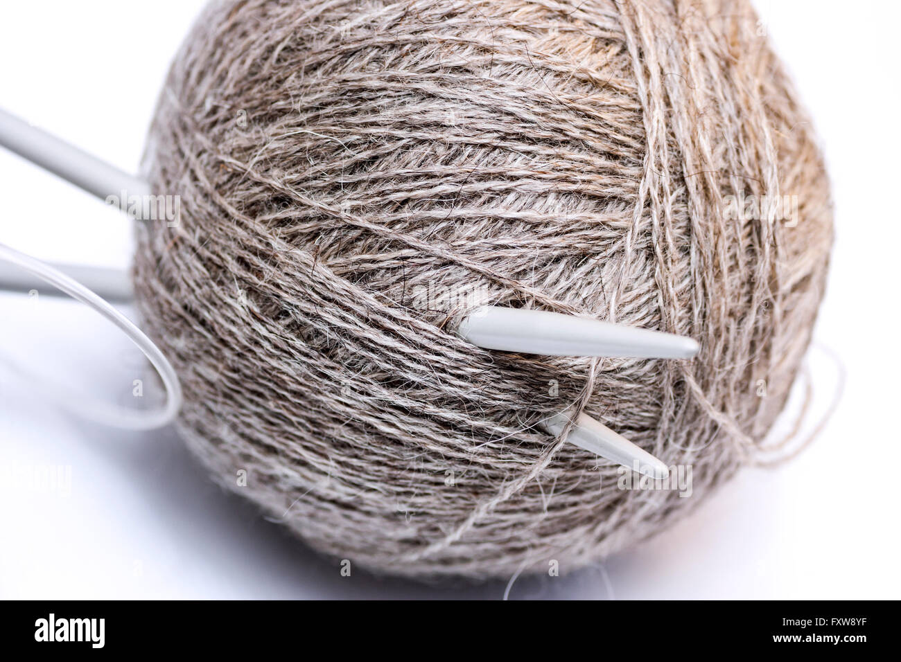 Wool yarn and knitting needles on white background Stock Photo - Alamy