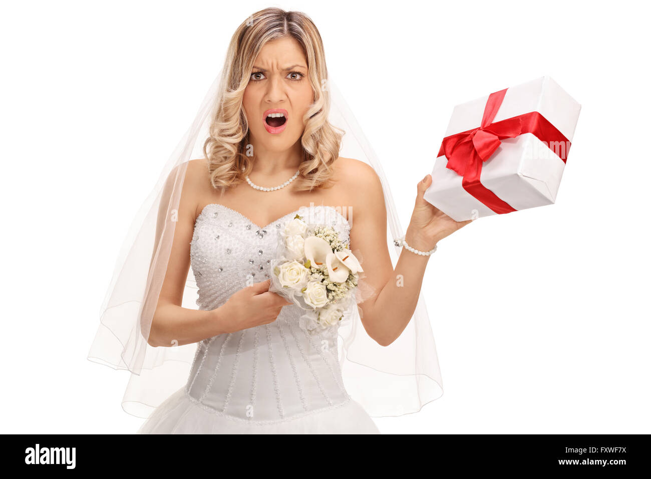 Young displeased bride holding a small wedding present isolated on white background Stock Photo