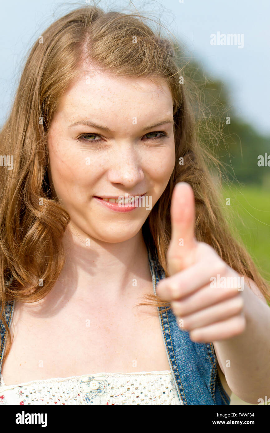 Young woman with thumb up Stock Photo