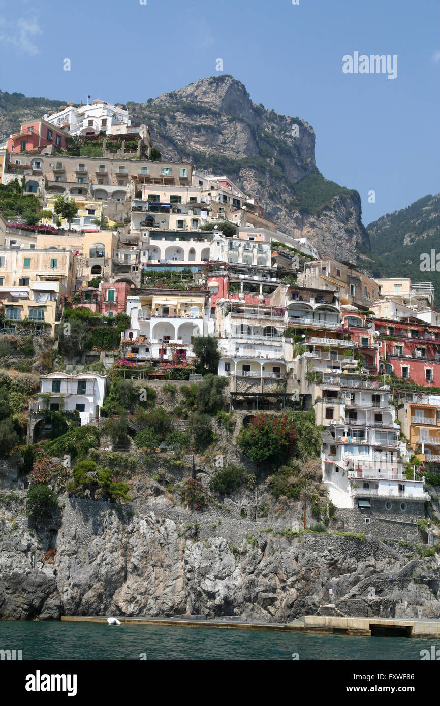 Houses and Hotels cling perilously to the cliff face at  beautiful Positano on the Amalfi Coast of Italy. Stock Photo