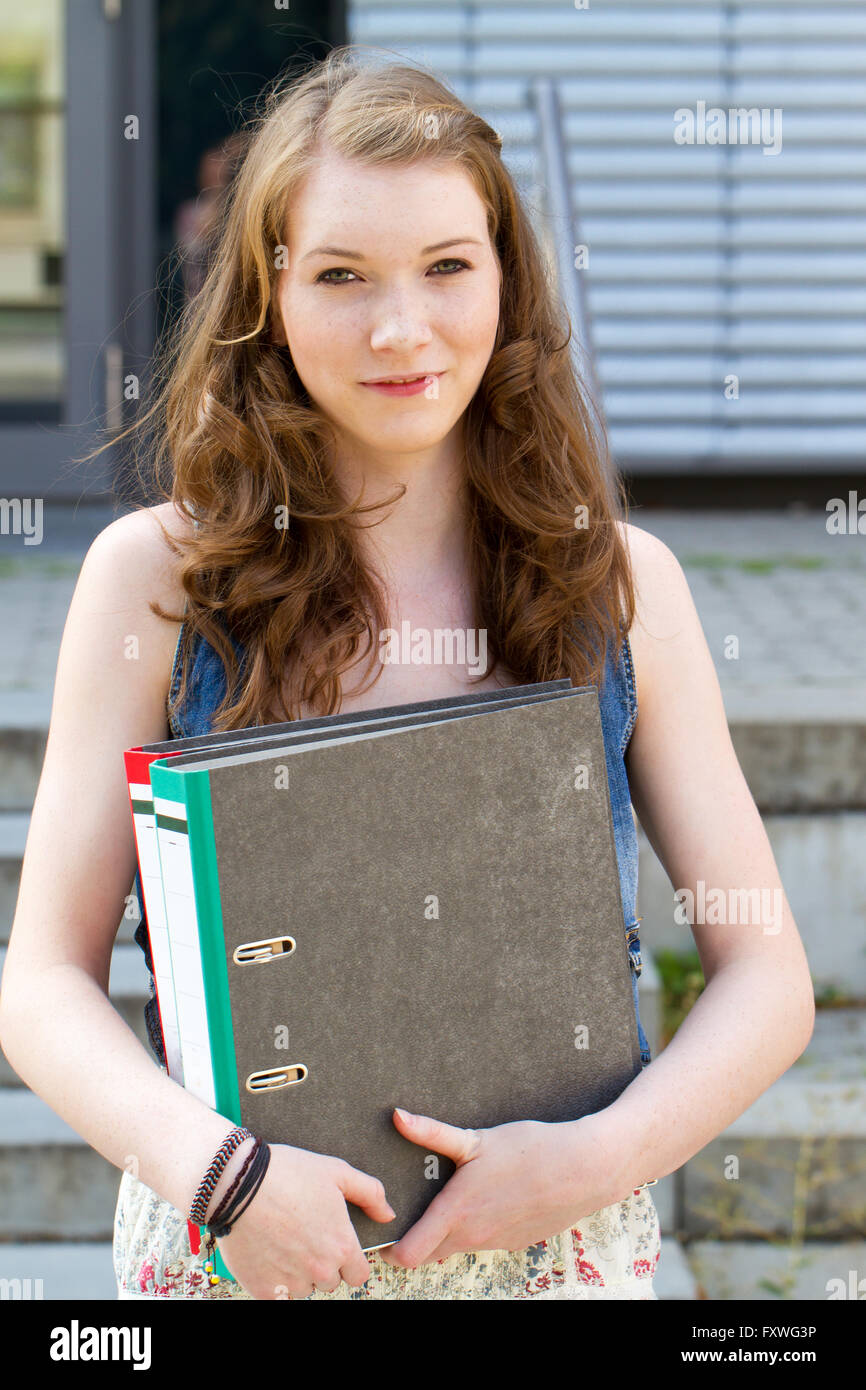 Young student with folders in the hands Stock Photo
