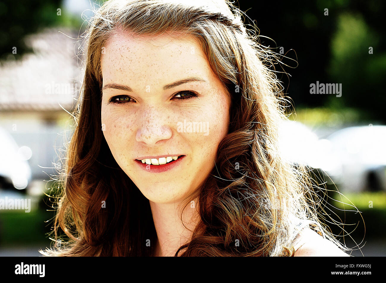 Portrait of a young, smiling woman with freckles Stock Photo