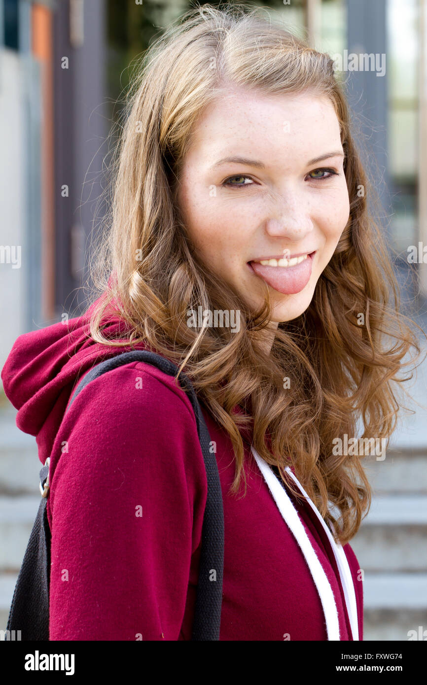 Young woman sticking tongue out Stock Photo