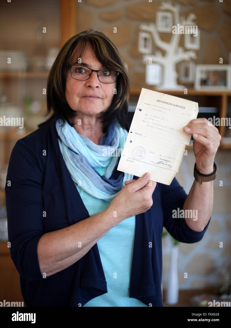 Coesfeld, Germany. 18th Apr, 2016. 66-year-old Inge Lohmann standing with her ancestry certificate in her living room in Coesfeld, Germany, 18 April 2016. The Federal Constitutional Court judges on 19 April 2016 whether Inge Lohmann can force a man that she supposes to be her father to do a DNA test. PHOTO: INA FASSBENDER/dpa/Alamy Live News Stock Photo
