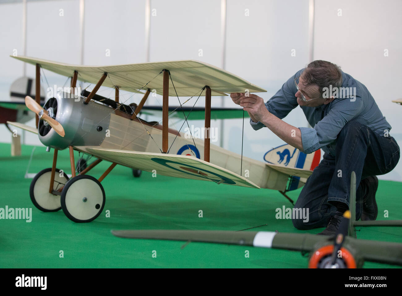 Dortmund, Germany. 19th Apr, 2016. Exhibitor Vasilij working on the plane model 'Sopwith Pup' at the modelling fair 'Intermodellbau' in Dortmund, Germany, 19 April 2016. The world's biggest fair for modelling and model sports takes place from 20 to 25 April 2016. PHOTO: MAJA HITIJ/dpa/Alamy Live News Stock Photo