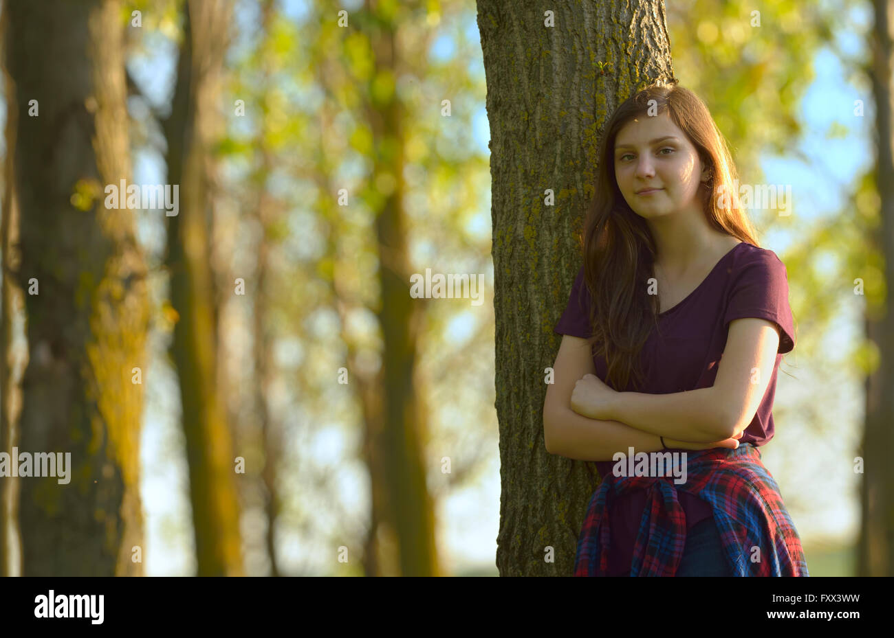 Portrait of a Pretty Teen Girl Standing in a Forest Stock Photo