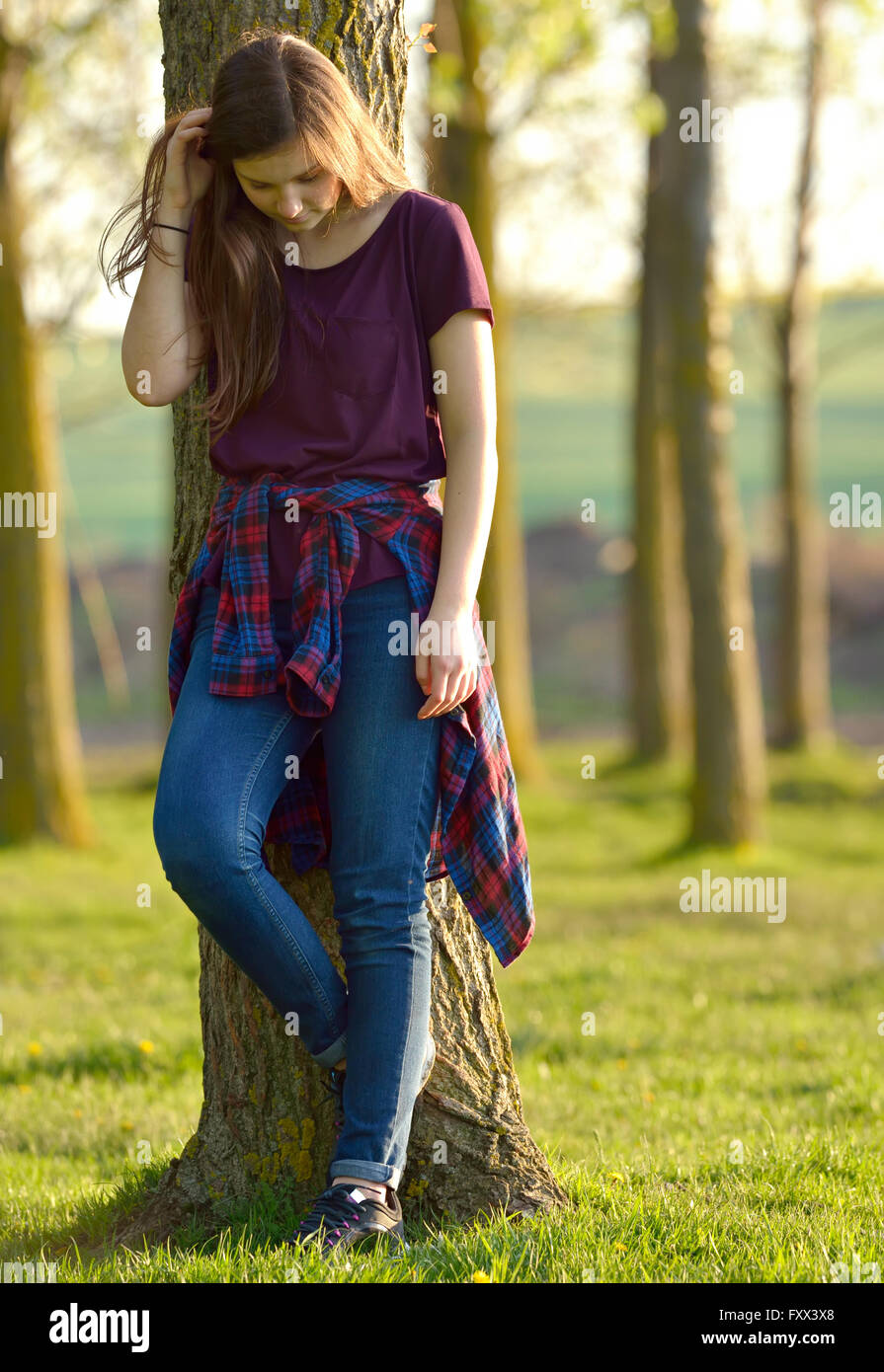 Portrait of a Pretty Teen Girl Standing in a Forest Stock Photo