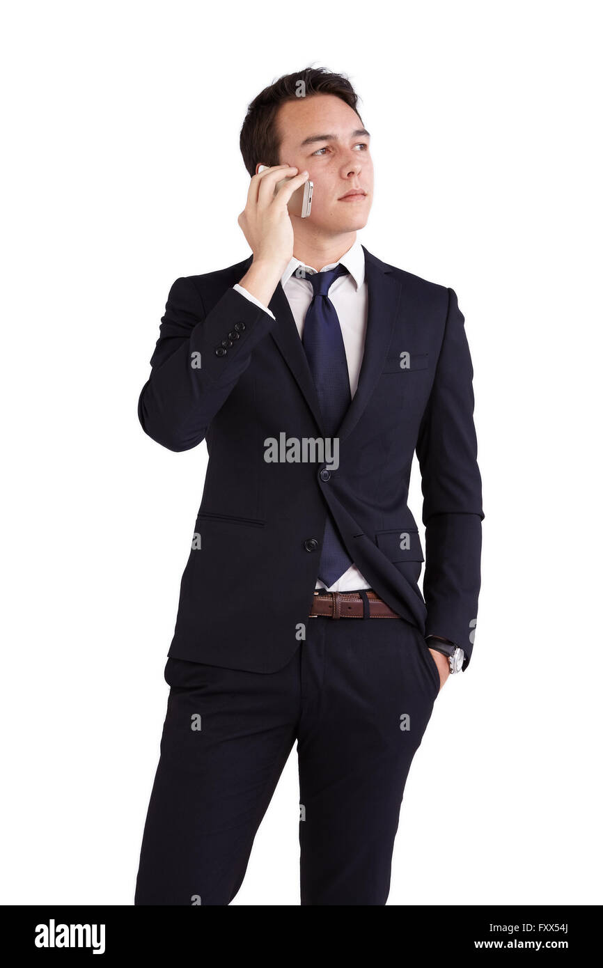 A young caucasian male businessman looking thoughtful holding a mobile phone looking away from camera. Stock Photo