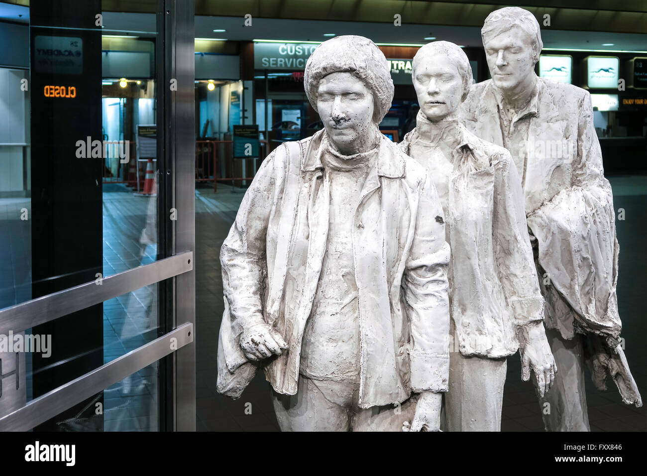 The life-size sculpture of three travelers in line at a boarding gate is on permanent exhibit and the artist is George Siegel. Stock Photo