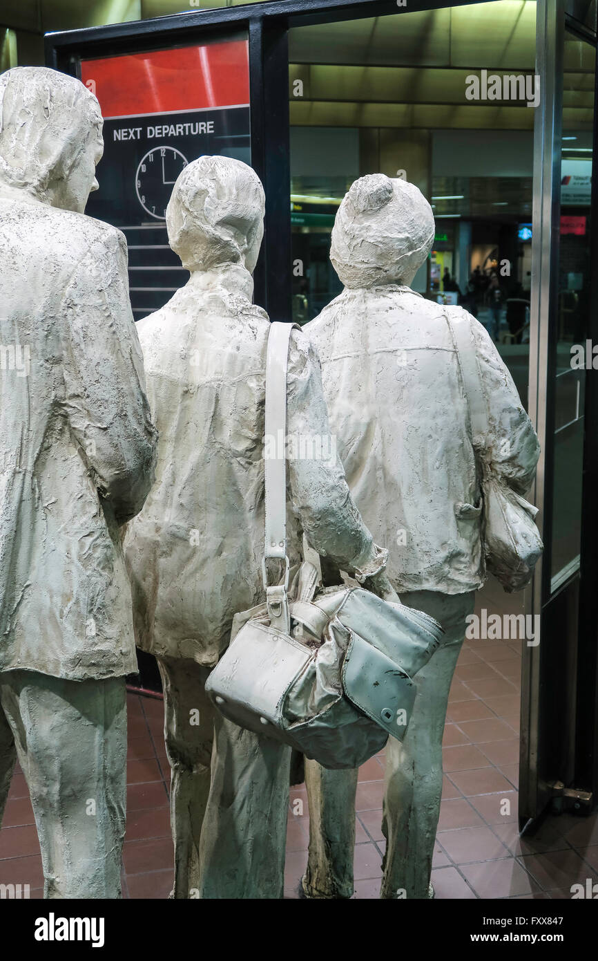 The life-size sculpture of three travelers in line at a boarding gate is on permanent exhibit and the artist is George Siegel. Stock Photo