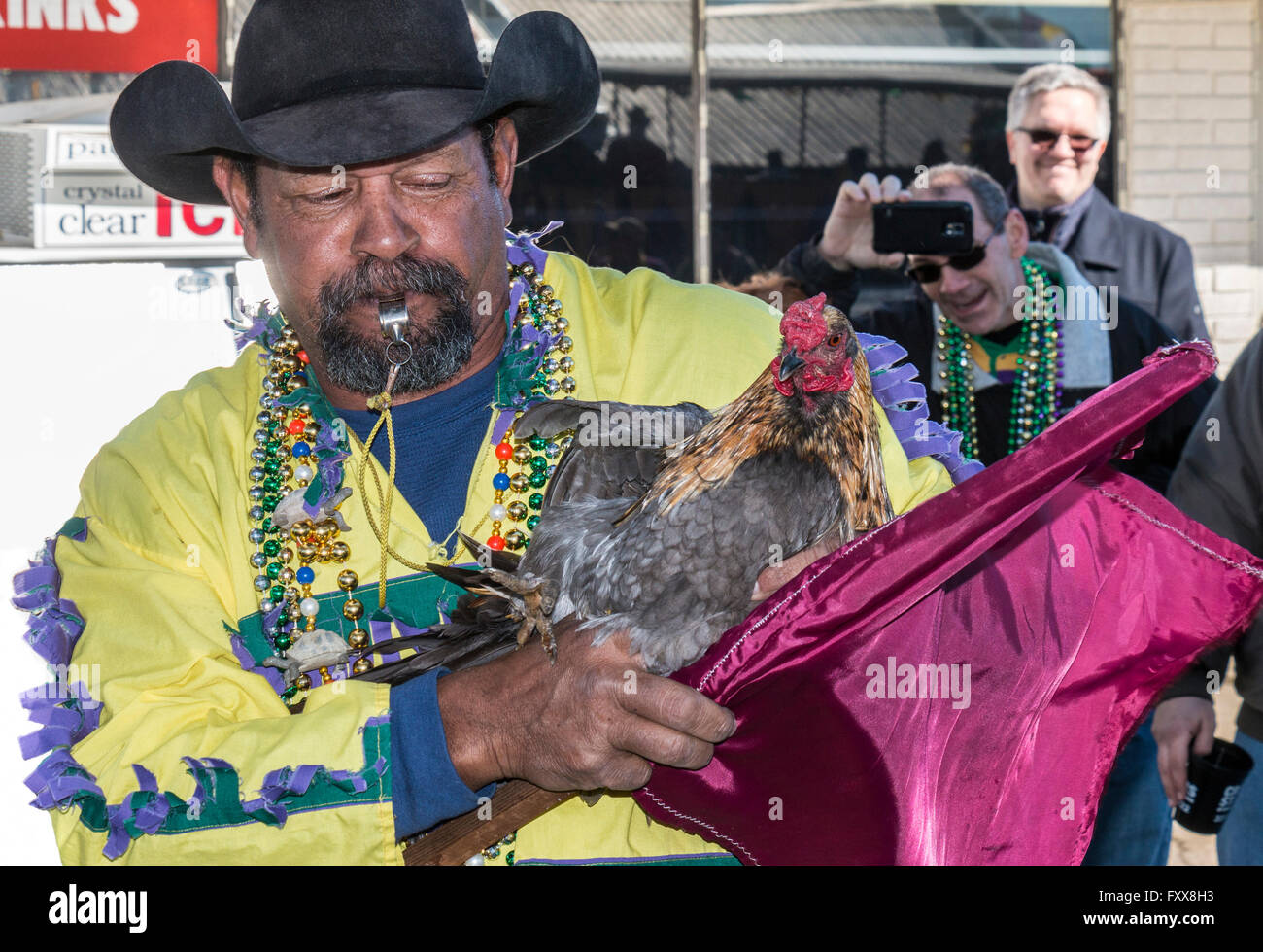 Rodney Victorian, chicken caption, holds one of his prize roosters for