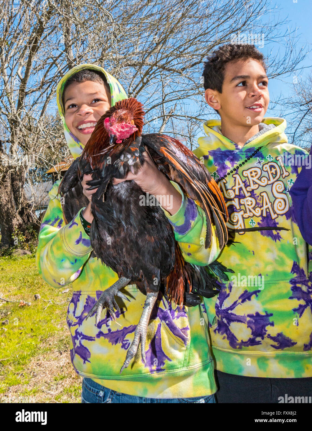 Victorious young boy chicken catcher during the traditional Chicken Run