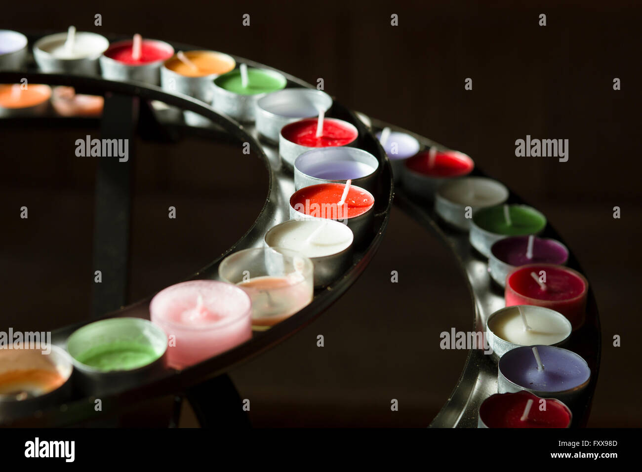 Rings of colourful candles in a holder at the church of St John, Charfield, Gloucestershire
