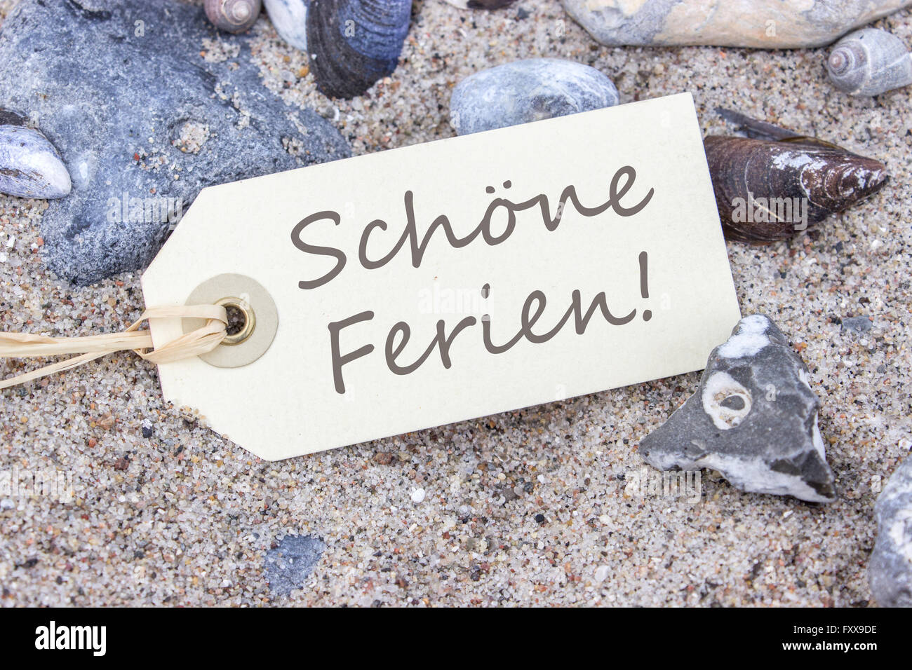 Card with german text “Lovely holiday” in the beach sand Stock Photo