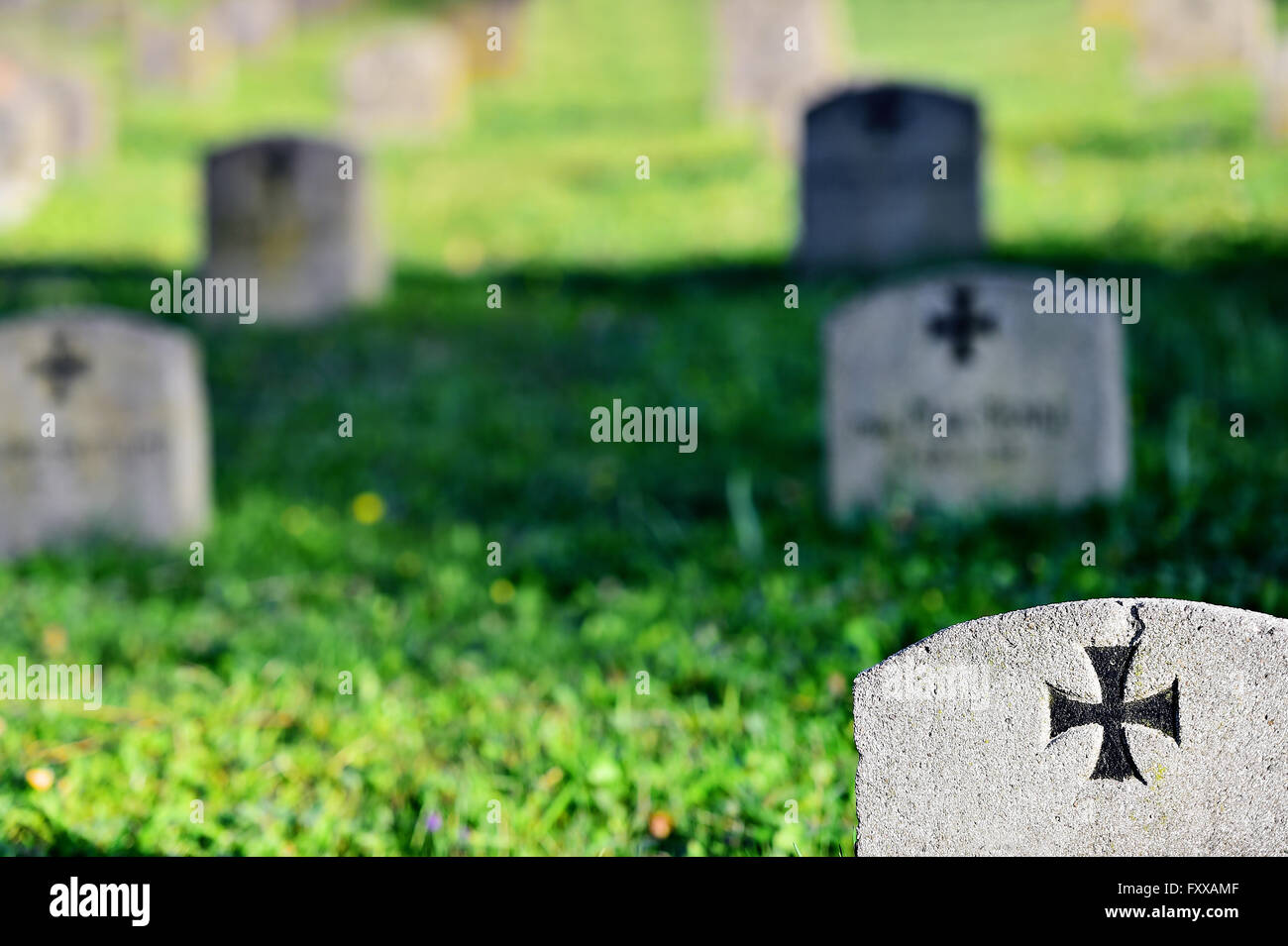 Gravestone of a german soldier with the iron cross symbol in a heroes graveyard Stock Photo