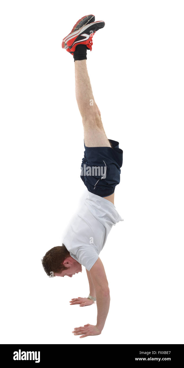 man doing the handstand isolated over a white background Stock Photo