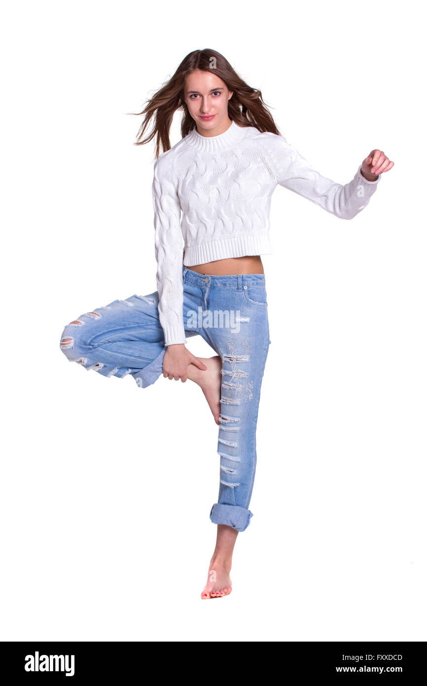 Pretty young woman posing in blue jeanse barefoot Stock Photo