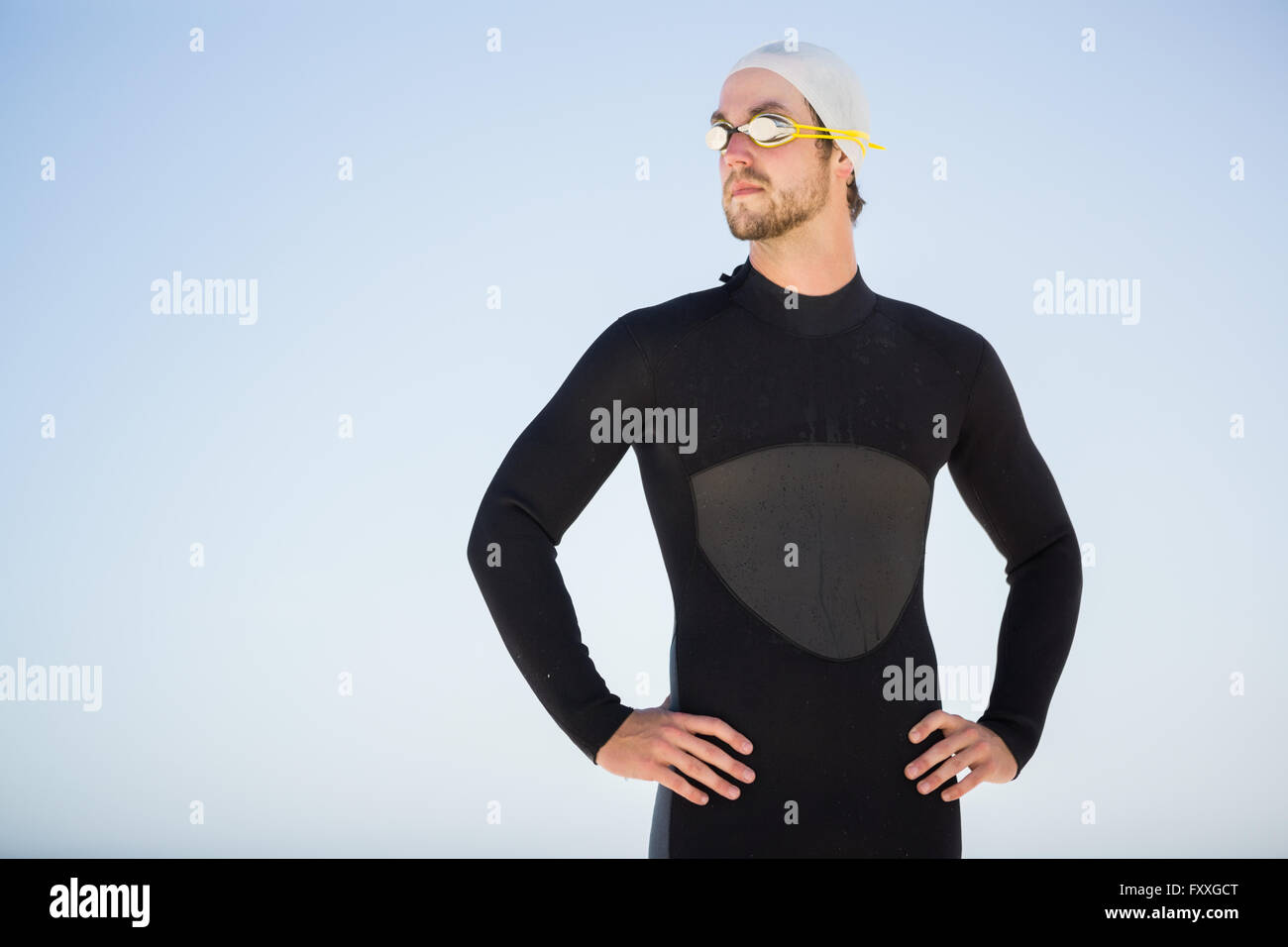 Young man wearing swimming cap and goggles hires stock photography and