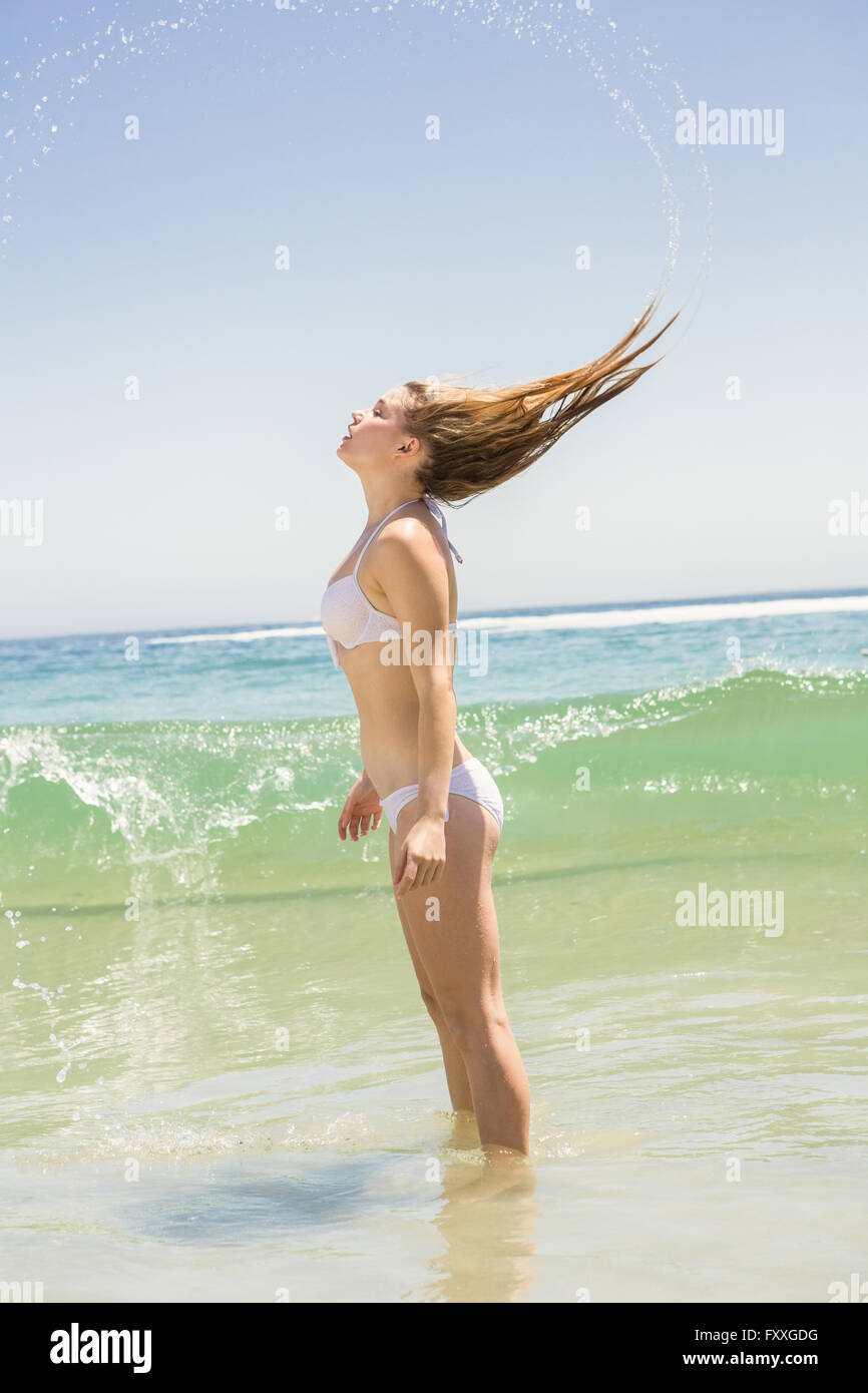 Blonde woman tossing her wet hair Stock Photo